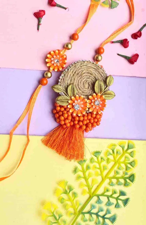 Couple_rakhi_for_bhaiya_and_bhabhi_with_orange_colour_flower_and_jute_base