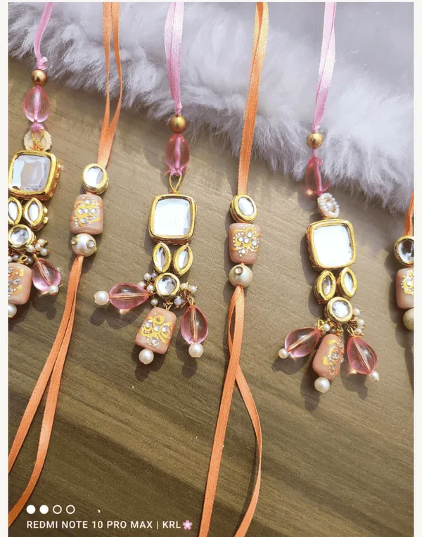 Jadau_couple_rakhi_with_peach_motif_and_hanging