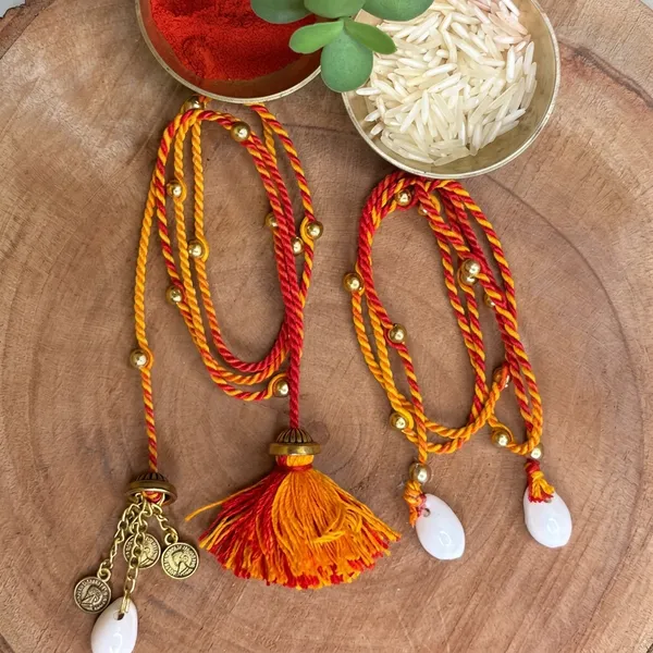 Handmade_Couple_Rakhi_Set_for_Bhaiya_Bhabhi,_Traditional_Mauli_Thread_Rakhi,_Festive_Lumba_Set_with_Kauri_Shells,_Coins_and_Tassels