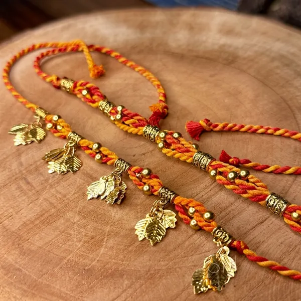 Handmade_Bhaiya_Bhabhi_Couple_Rakhi_Set,_Traditional_Moli_Thread_Rakhi,_Festive_Lumba_Set_with_Golden_Leaf_Charms_and_Antique_Beads