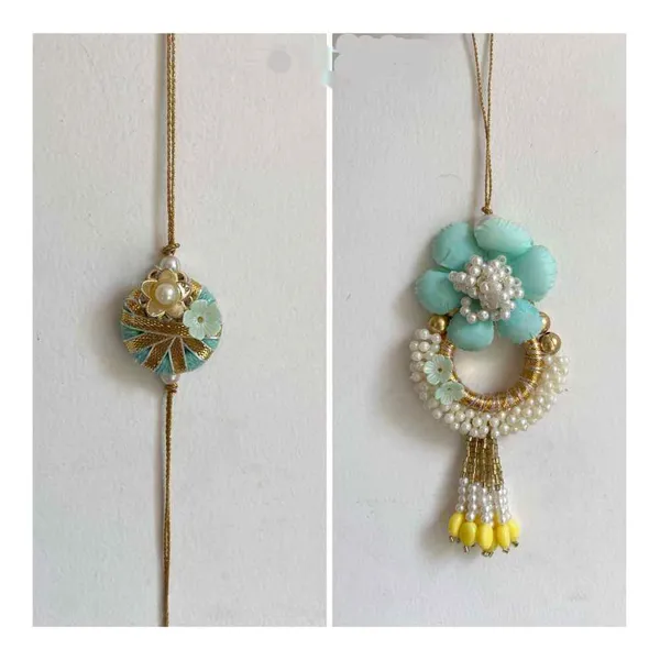 Couple_rakhi_with_beautiful_white_pearls_ring_flower_design