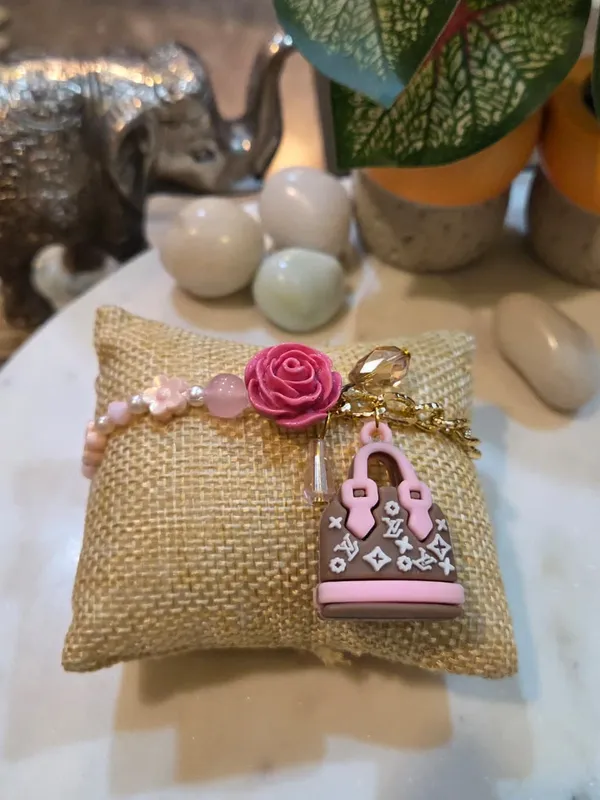 Rosé_Luxe_Handbag_Charm_Rakhi_with_Floral_Accent_Premium_Designer_Raksha_Bandhan_Thread_for_Sister_Handmade_Fashion_Rakhi
