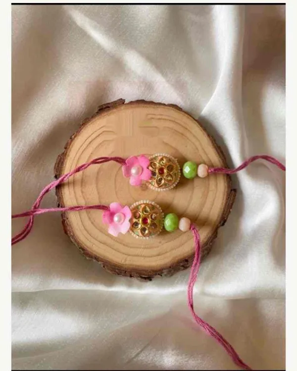 small_size_jadau_piece_rakhi_with_flower_on_one_side