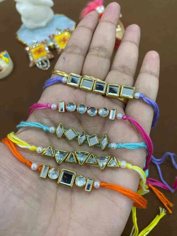 Jadau_rakhi_for_bhai_which_comes_in_different_shapes_and_thread_of_different_colours_.