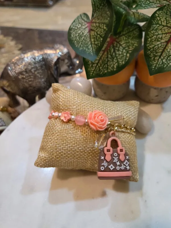 Rosé_Luxe_Handbag_Charm_Rakhi_with_Floral_Accent_Premium_Designer_Raksha_Bandhan_Thread_for_Sister_Handmade_Fashion_Rakhi