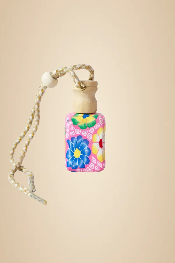 Decorative_Perfume_Bottle_With_Floral_Design_And_Hanging_Cord