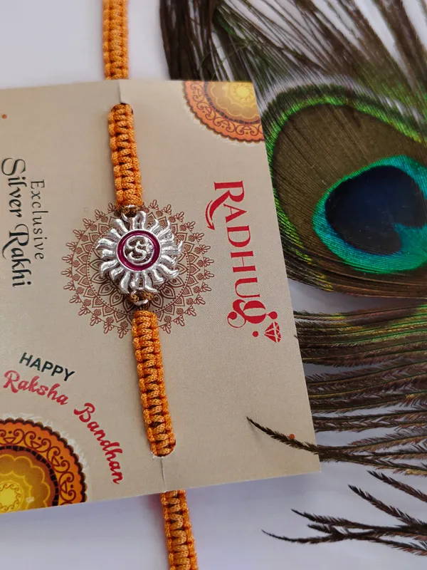 Pack_Of_1_Silver_Om_Surya_Charm_Braided_Orange_Thread_Rakhi