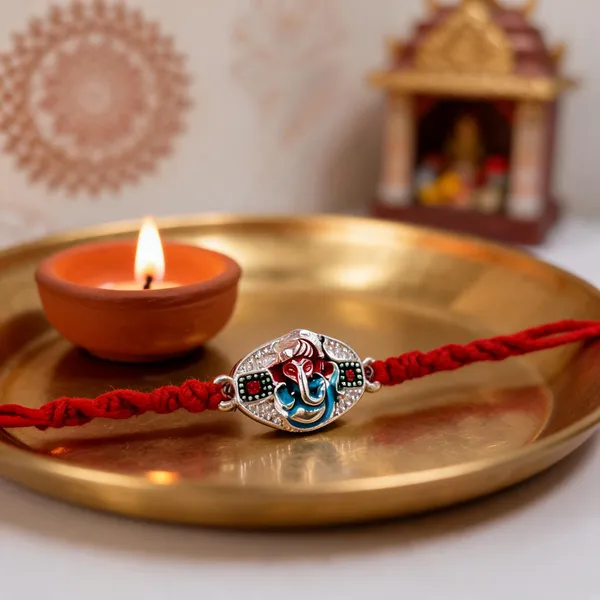Pack_Of_1_Silver_Blessing_Ganesh_Enamel_Charm_Red_Thread_Rakhi