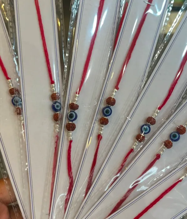 Pack_Of_1_Silver_Evil_Eye_Rudraksha_Red_Cotton_Thread_Rakhi