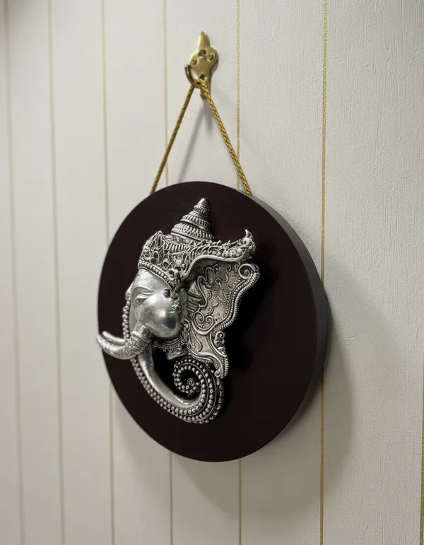 Pure_Silver_Divine_Ganesha_Face_Handcrafted_Relief_On_Circular_Wood_Stand_Wall_Hanging