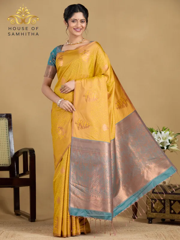 Sunshine_Yellow_Semi-Soft_Silk_Saree_With_Copper_Tree_Buttas_&_Contrast_Teal_Border