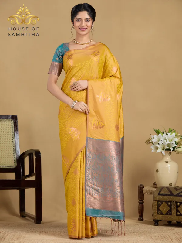 Sunshine_Yellow_Semi-Soft_Silk_Saree_With_Copper_Tree_Buttas_&_Contrast_Teal_Border