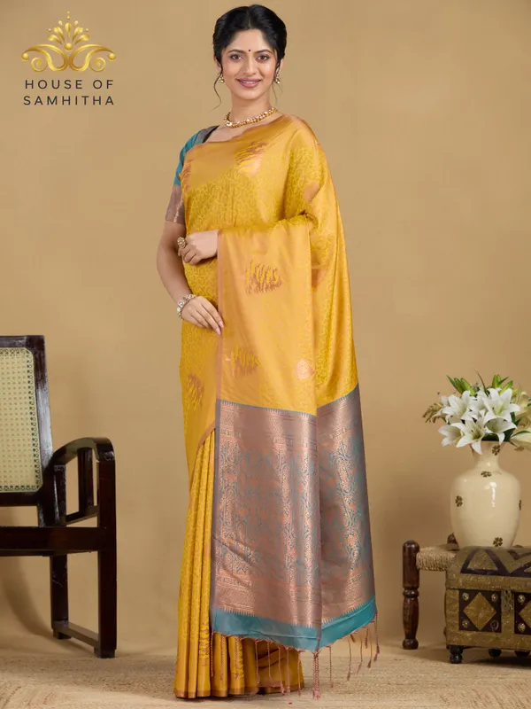 Sunshine_Yellow_Semi-Soft_Silk_Saree_With_Copper_Tree_Buttas_&_Contrast_Teal_Border