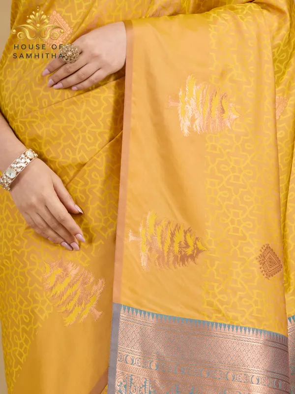 Sunshine_Yellow_Semi-Soft_Silk_Saree_With_Copper_Tree_Buttas_&_Contrast_Teal_Border