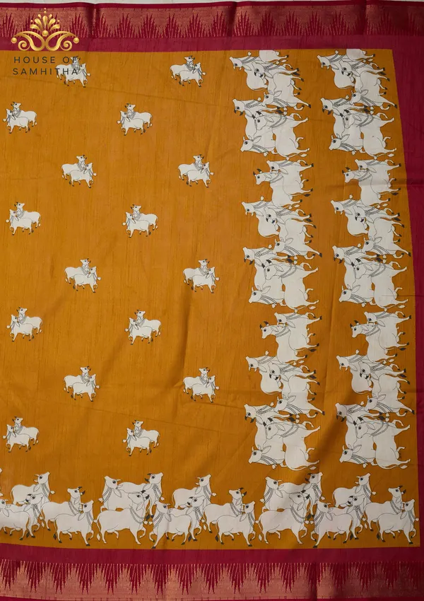 Mustard_Dola_Silk_Saree_Featuring_Traditional_Pichwai_Cow_Art_And_Contrast_Maroon_Zari_Border