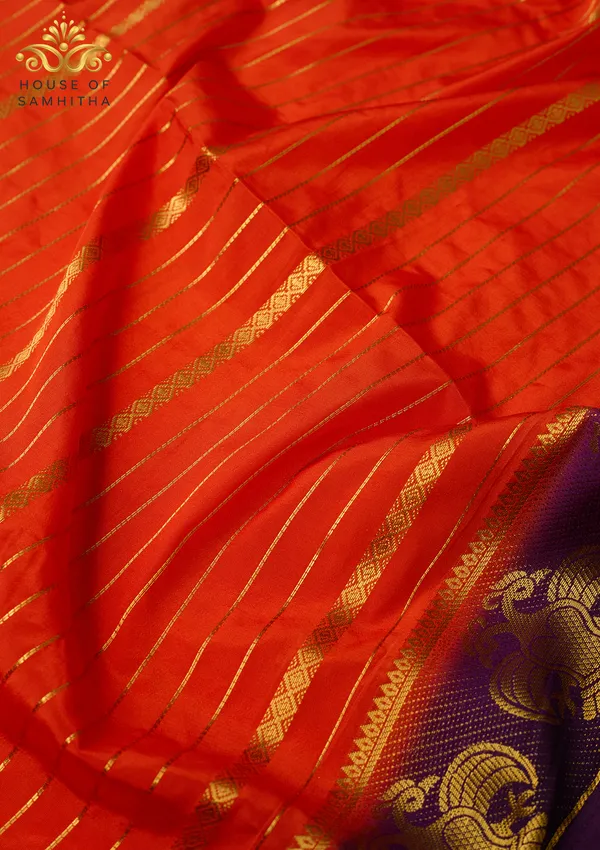 Radiant_Orange_Semi-Crepe_Silk_Saree_With_Horizontal_Zari_Stripes_And_Rich_Purple_Gandaberunda_Border