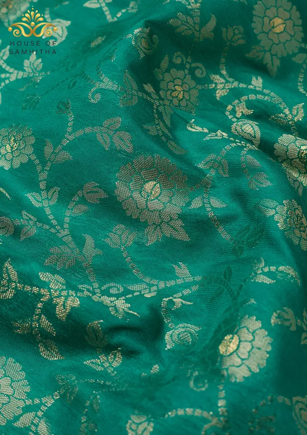Charming_Sea_Green_Banarasi_Imitation_Semi-Silk_Saree_With_Floral_Zari_Brocade_And_Contrast_Rani_Pink_Border