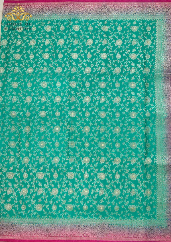 Charming_Sea_Green_Banarasi_Imitation_Semi-Silk_Saree_With_Floral_Zari_Brocade_And_Contrast_Rani_Pink_Border