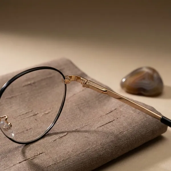 Gold_And_Black_Titanium_Oval_Rim_Metal_Optical_Frame_For_Women_With_Bule_Cut_Glasses