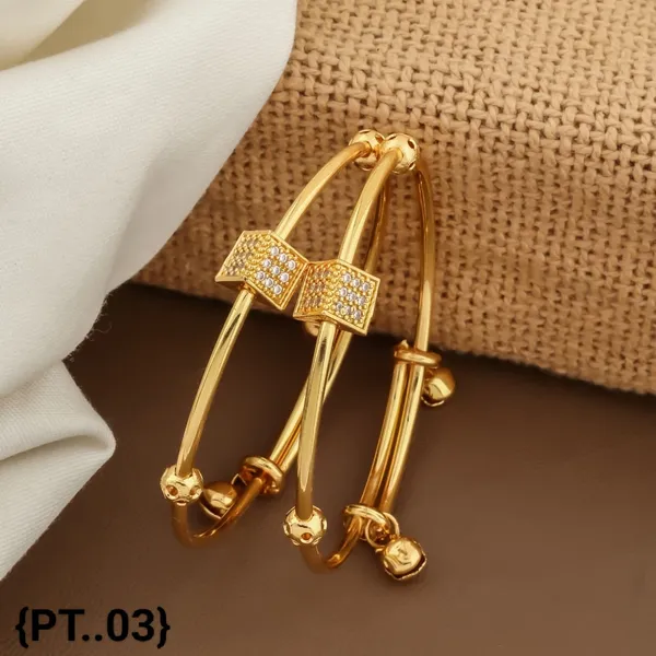 Elegant_Gold_Toned_Bangle_Set_With_Crystal_Bow_Accent