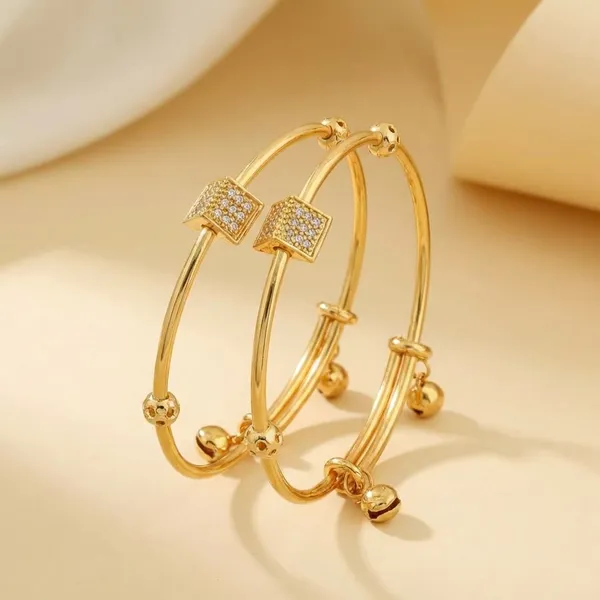 Elegant_Gold_Toned_Bangle_Set_With_Crystal_Bow_Accent