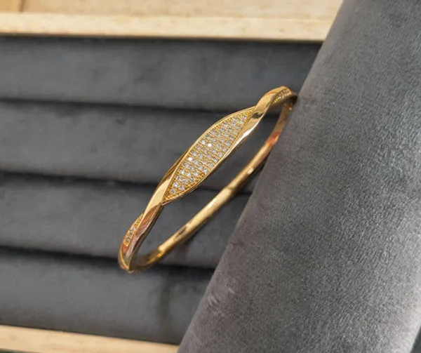 Golden_Twisted_Bangle_With_Crystal_Embellishments_For_Women