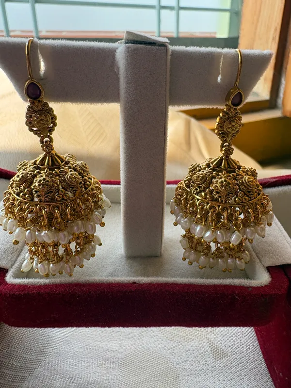 Pack_Of_2-Traditional_Gold_Toned_Jhumka_Earrings_With_Pearl_Bead_Fringe_And_Antique_Gold_Chandbali_Earrings_With_Green_And_Red_Stones