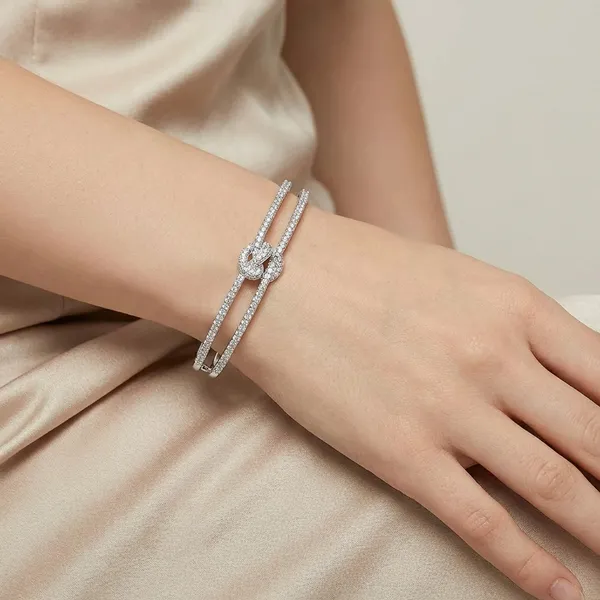 Multi_Layer_Crystal_Studded_Silver_Toned_Bangle_Bracelet_With_Infinity_Knot_Design_For_Women
