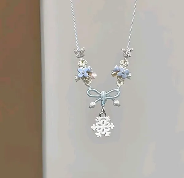 Elegant_Silver_Toned_Floral_Bow_Pendant_Necklace_With_Blue_Accents_For_Women
