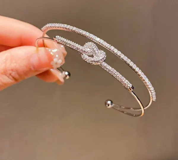Multi_Layer_Crystal_Studded_Silver_Toned_Bangle_Bracelet_With_Infinity_Knot_Design_For_Women