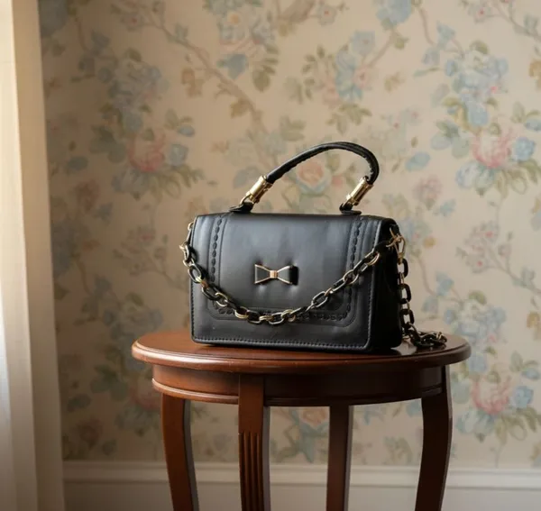 Black_Faux_Leather_Handbag_with_Gold_Chain_and_Bow_Detail