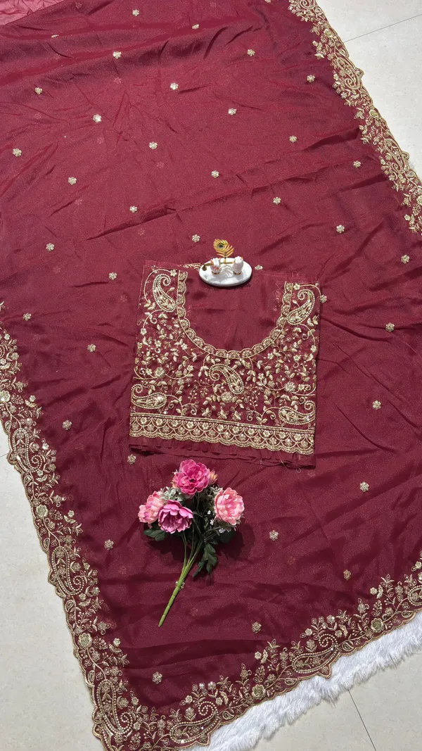 Exquisite_Maroon_Embroidered_Saree_Elevate_your_ethnic_look_with_this_stunning_maroon_saree_featuring_a_rich,_intricate_zari_border_and_delicate_floral_motifs._Crafted_from_premium_lightweight_fabric,_it_comes_with_a_heavily_embroidered_designer_blouse_piece_for_a_complete_royal_look._Perfect_for_weddings_and_festive_occasions.