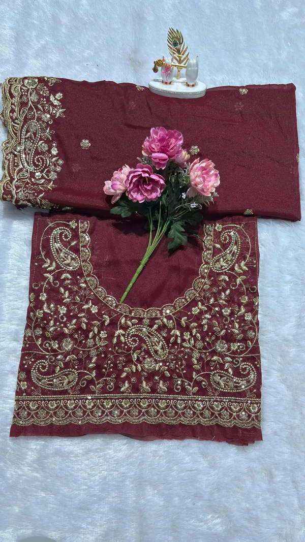 Exquisite_Maroon_Embroidered_Saree_Elevate_your_ethnic_look_with_this_stunning_maroon_saree_featuring_a_rich,_intricate_zari_border_and_delicate_floral_motifs._Crafted_from_premium_lightweight_fabric,_it_comes_with_a_heavily_embroidered_designer_blouse_piece_for_a_complete_royal_look._Perfect_for_weddings_and_festive_occasions.