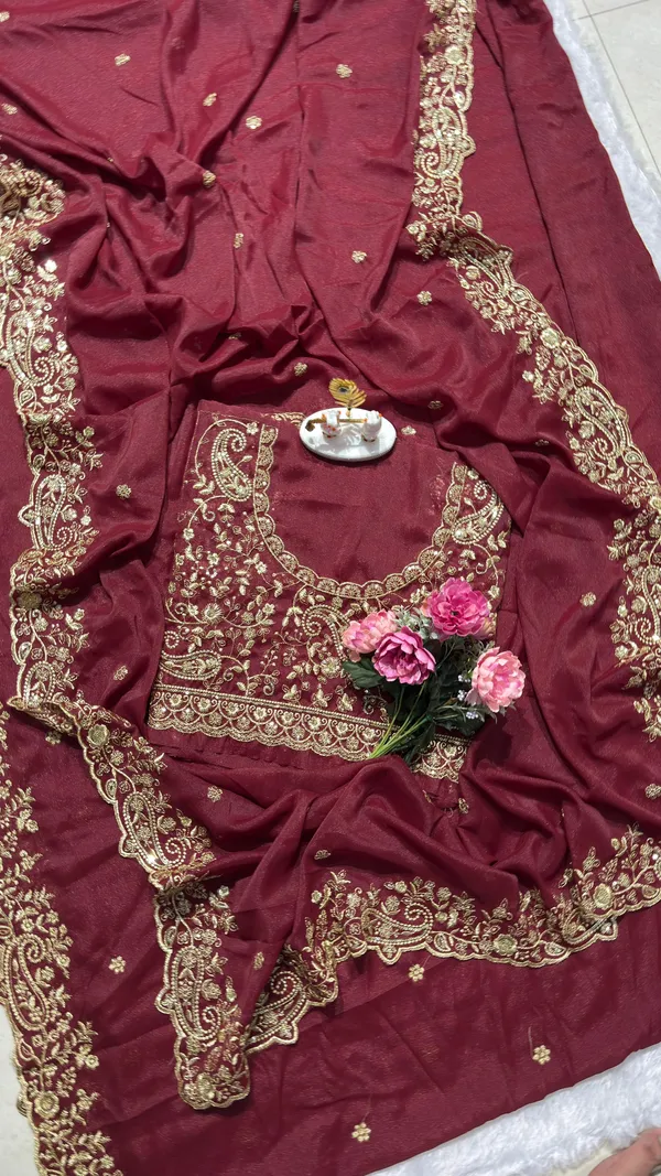Exquisite_Maroon_Embroidered_Saree_Elevate_your_ethnic_look_with_this_stunning_maroon_saree_featuring_a_rich,_intricate_zari_border_and_delicate_floral_motifs._Crafted_from_premium_lightweight_fabric,_it_comes_with_a_heavily_embroidered_designer_blouse_piece_for_a_complete_royal_look._Perfect_for_weddings_and_festive_occasions.