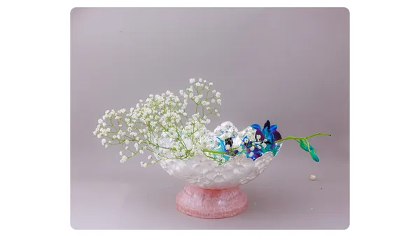 Decorative_Floral_Arrangement_In_Pink_Glass_Vase