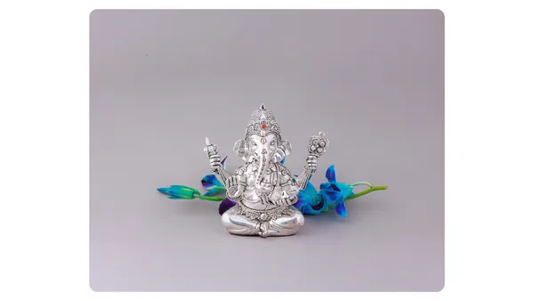 Silver-Plated_Lord_Ganesha_Idol_With_Blue_Orchid_Flowers