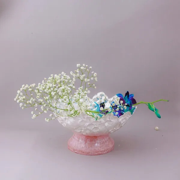 Decorative_Floral_Arrangement_In_Pink_Glass_Vase