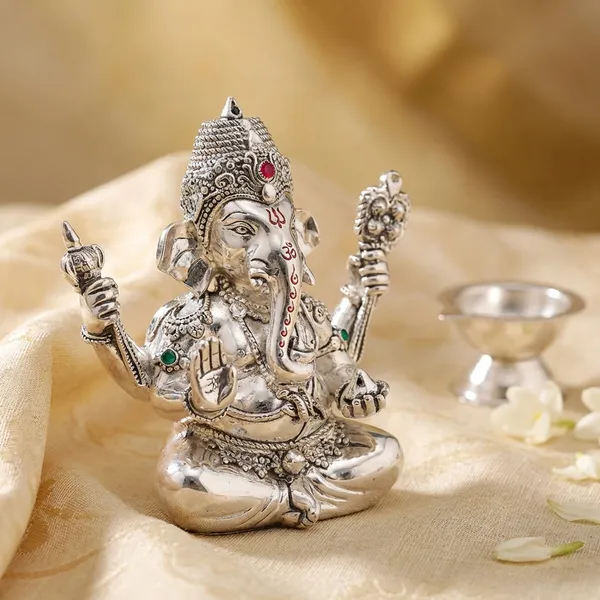 Silver-Plated_Lord_Ganesha_Idol_With_Blue_Orchid_Flowers