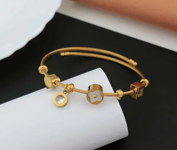Gold_Tone_Adjustable_Charm_Bracelet_With_Floral_And_Circle_Pendants_For_Women