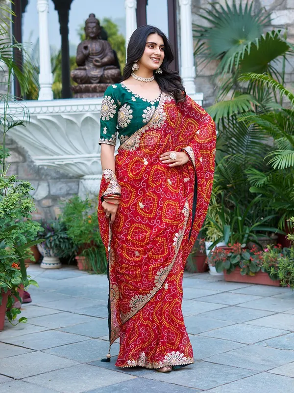Traditional_Red_Bandhani_Saree_With_Embellished_Border_And_Green_Blouse