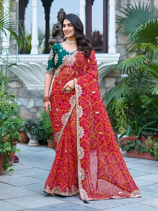 Traditional_Red_Bandhani_Saree_With_Embellished_Border_And_Green_Blouse