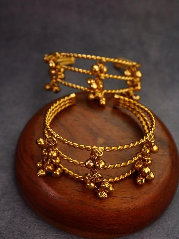 GOLDEN_GHUNGROO_KADA__Metal:_Brass_Stone:_No_Stone_Only_Ghungroo_Size:_Adjustable_Quantity:_1_Pair_Care_Tips:__After_use,_store_in_a_zip-lock_pouch_to_maintain_shine_and_prevent_tarnishing._Avoid_contact_with_water_and_perfume_to_preserve_quality_and_color.