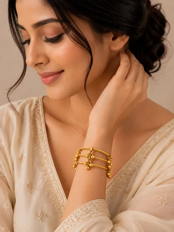 GOLDEN_GHUNGROO_KADA__Metal:_Brass_Stone:_No_Stone_Only_Ghungroo_Size:_Adjustable_Quantity:_1_Pair_Care_Tips:__After_use,_store_in_a_zip-lock_pouch_to_maintain_shine_and_prevent_tarnishing._Avoid_contact_with_water_and_perfume_to_preserve_quality_and_color.