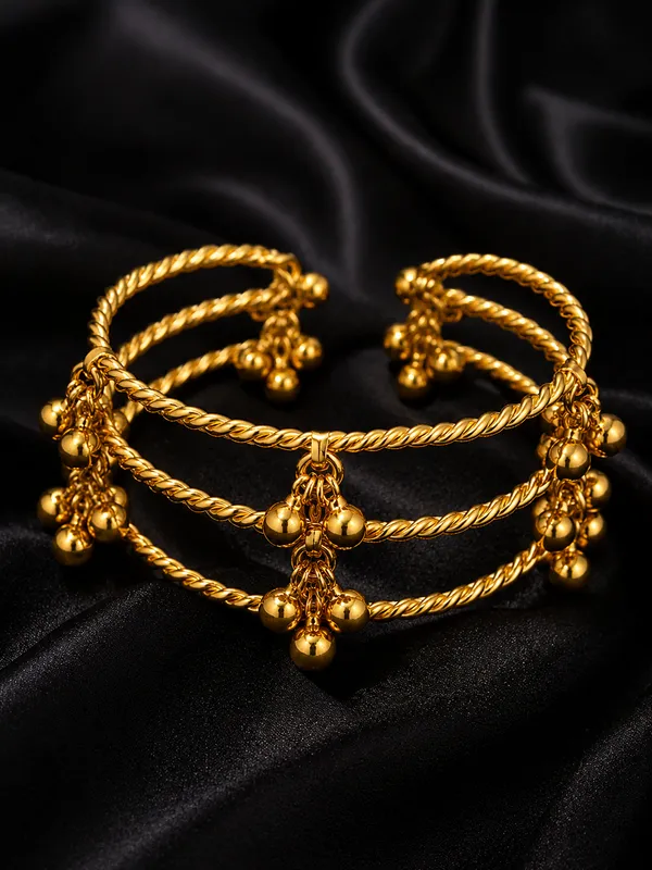 GOLDEN_GHUNGROO_KADA__Metal:_Brass_Stone:_No_Stone_Only_Ghungroo_Size:_Adjustable_Quantity:_1_Pair_Care_Tips:__After_use,_store_in_a_zip-lock_pouch_to_maintain_shine_and_prevent_tarnishing._Avoid_contact_with_water_and_perfume_to_preserve_quality_and_color.