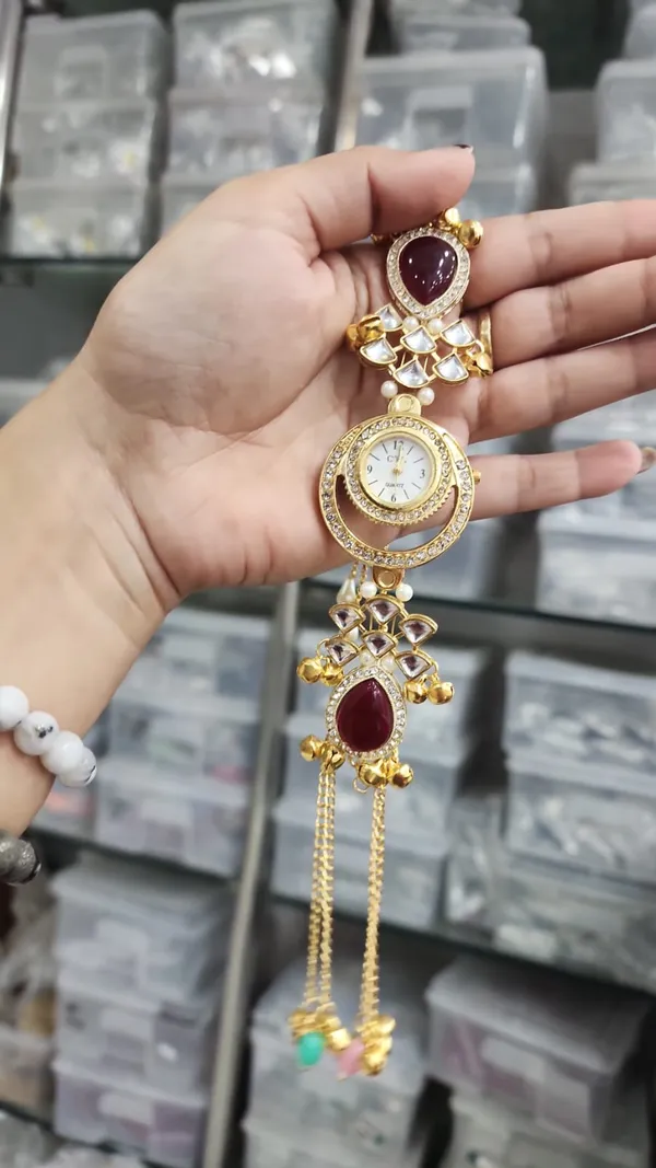 Deep_maroon_teardrop_resin/glass_stones,_accented_with_white_Kundan-style_polki_work_and_delicate_faux_pearls.