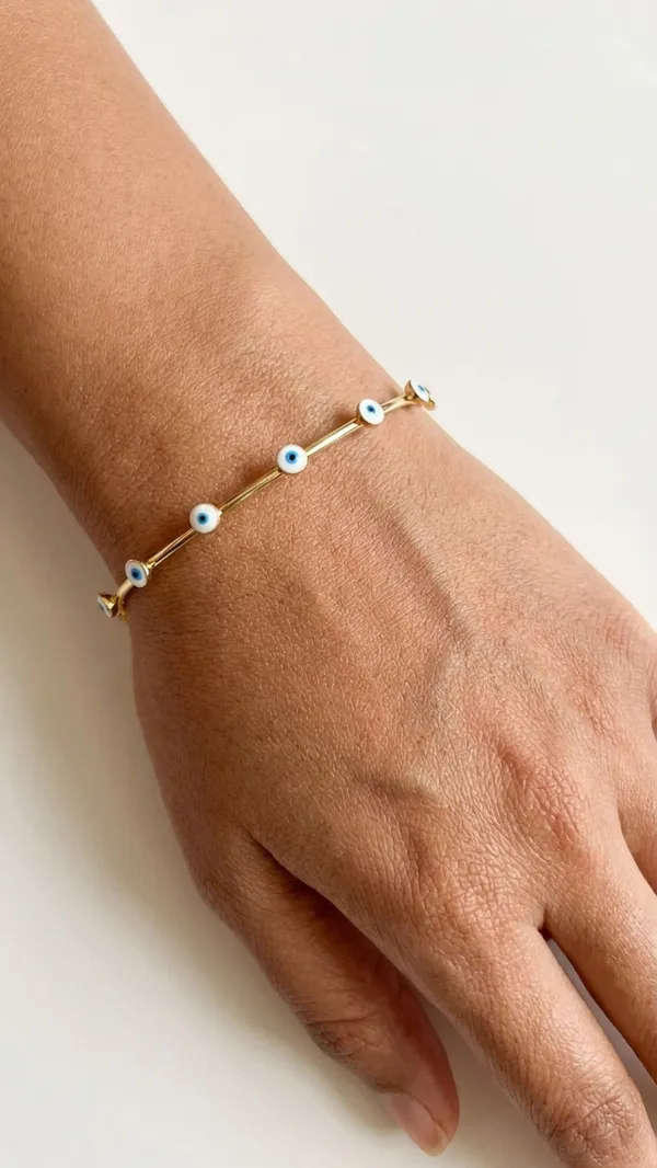 Gold_Tone_Bangle_With_Blue_Evil_Eye_Charms_For_Women