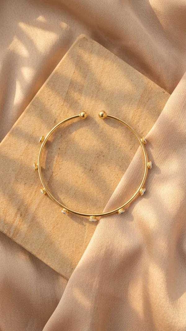 Gold_Tone_Bangle_With_Blue_Evil_Eye_Charms_For_Women
