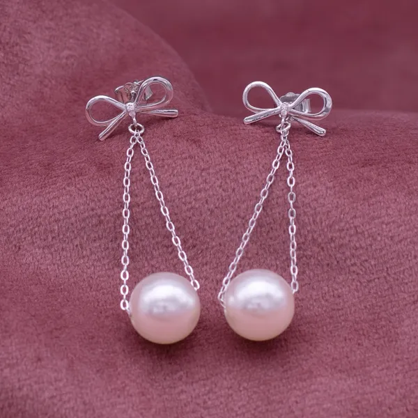 Hanging_lustrous_pearl_earrings_in_925_Silver_by_SVADEZI