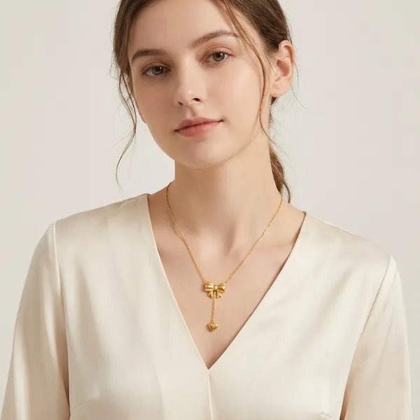 Elegant_Gold-Toned_Bow_Pendant_Necklace_With_Heart_Charm