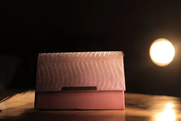 Elegant_Pink_Textured_Clutch_With_Woven_Flap_Design._Buy_1_Get_1_Free_Colour_May_Be_Varey